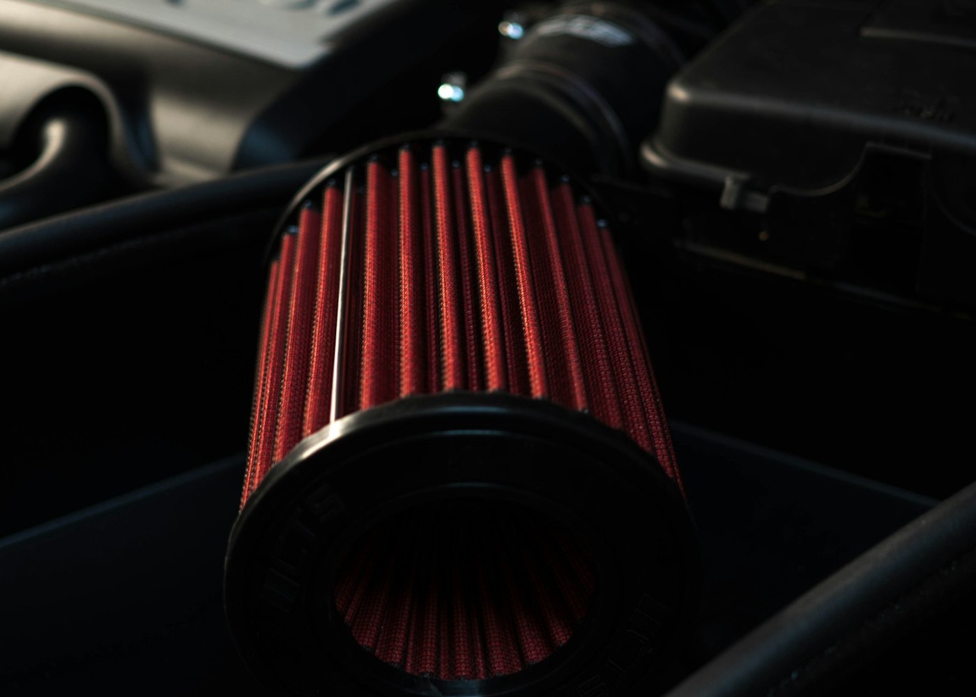 Cylindrical automotive air filter in an engine bay